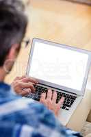 Man using a digital tablet in living room