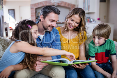 Happy family looking at a photo album