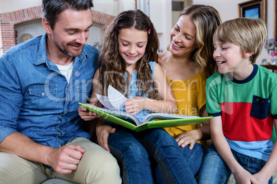 Happy family looking at a photo album