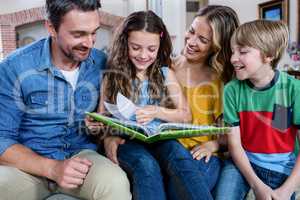 Happy family looking at a photo album