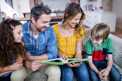 Happy family looking at a photo album