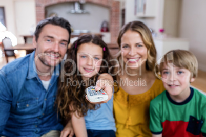 Family watching television in living room