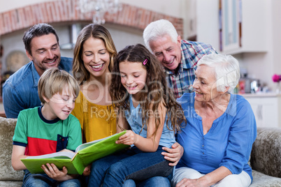 Multi-generation family looking at a photo album