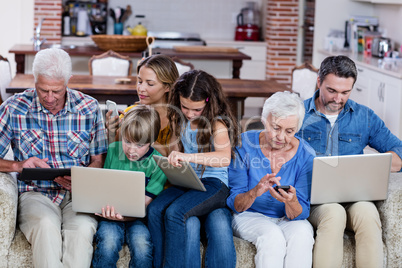 Multi-generation family using a laptop, tablet and phone