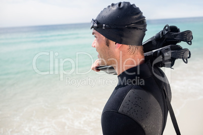 Surfer with flippers standing on the beach