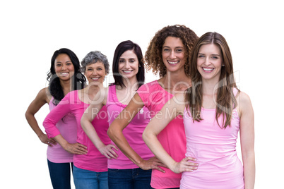 Smiling women in pink outfits posing for breast cancer awareness