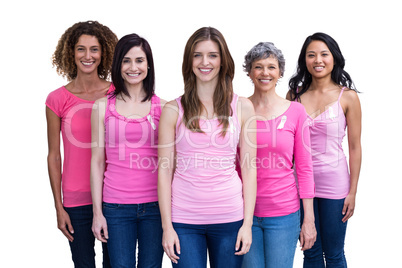 Smiling women in pink outfits posing for breast cancer awareness