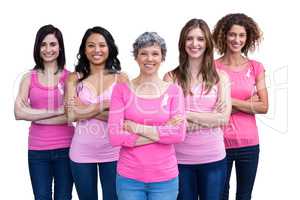 Smiling women in pink outfits posing for breast cancer awareness