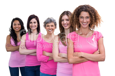 Smiling women in pink outfits standing in a line for breast canc