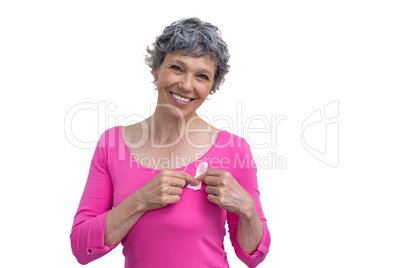 Woman in pink outfits showing ribbon for breast cancer awareness