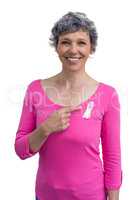 Woman in pink outfits showing ribbon for breast cancer awareness