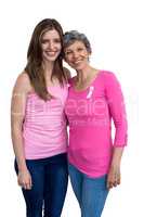 Smiling women in pink outfits posing for breast cancer awareness