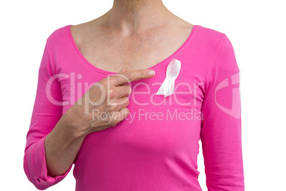 Woman in pink outfits showing ribbon for breast cancer awareness