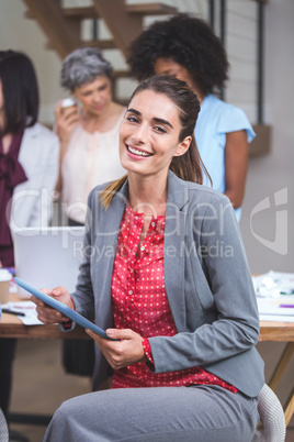 Happy businesswoman using digital tablet