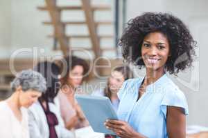 Portrait of happy businesswoman with digital tablet