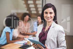 Portrait of happy businesswoman with digital tablet