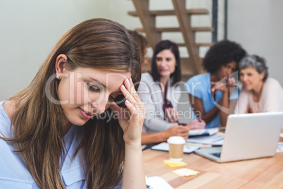 Tense businesswoman sitting in office