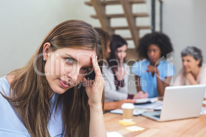 Tense businesswoman sitting in office