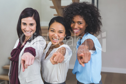 Portrait of business colleagues pointing sideways
