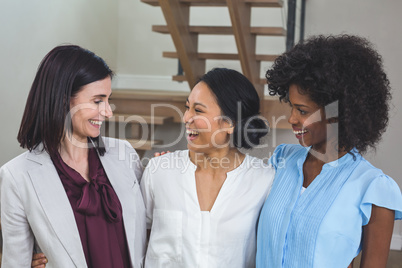 Happy female business colleagues standing together