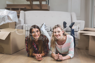 Friends lying together on the floor and smiling