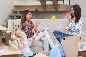 Playful friends throwing packing peanuts with each other