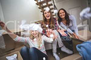 Playful friends playing with packing peanuts