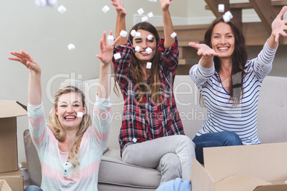 Playful friends playing with packing peanuts