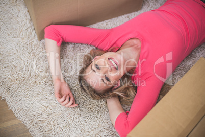 Beautiful woman lying on rug in living room