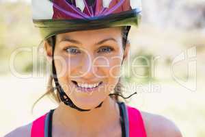 Fit smiling woman wearing helmet