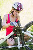 Woman fixing her bike