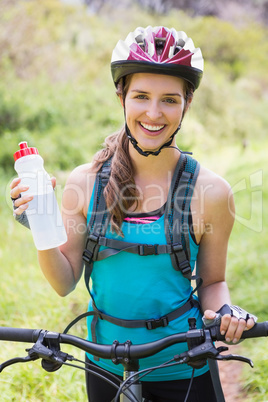 Smiling woman standing next to her bike