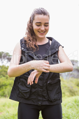 Smiling woman checking her watch