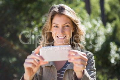 Smiling woman taking selfie