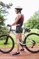 Woman standing with her bike