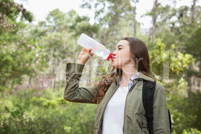 Woman drinking water with backpack