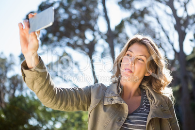 Happy woman taking selfie