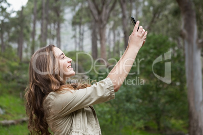 Smiling woman taking selfies