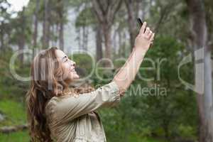 Smiling woman taking selfies