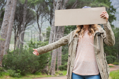 Hitch hiking woman holding cardboard