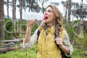 Woman drinking water while doing a break