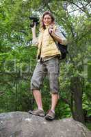 Smiling woman holding binoculars