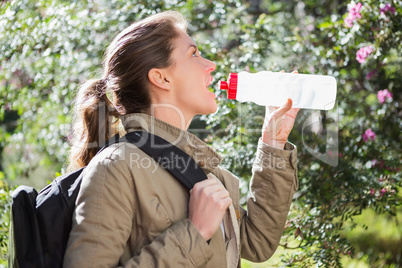 Woman drinking water while doing a break Woman drinking water while doing a break