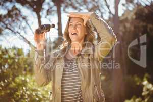 Smiling woman holding binoculars