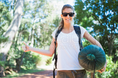 Hitch hiking woman with sleeping bag