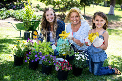 Portrait of grandmother, mother and daughter gardening together