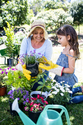 Grandmother and granddaughter gardening in the park