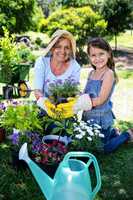 Grandmother and granddaughter gardening in the park