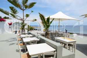 The outdoor restaurant near beach, Santorini island, Greece