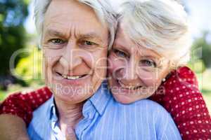 Happy senior couple embracing in park